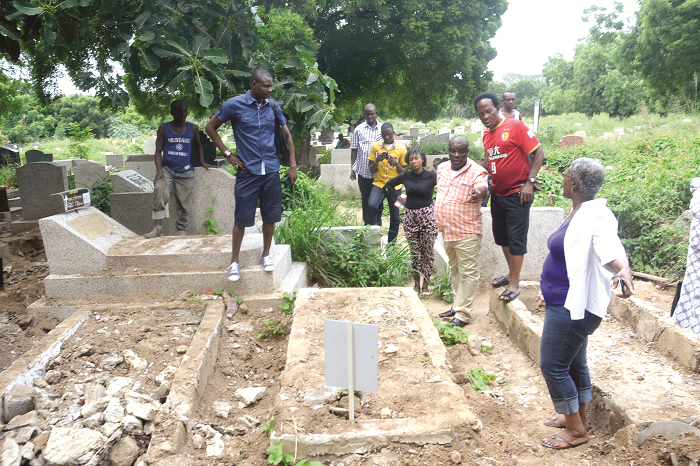 Some family members of the deceased show their anger at the  desecration of the grave
