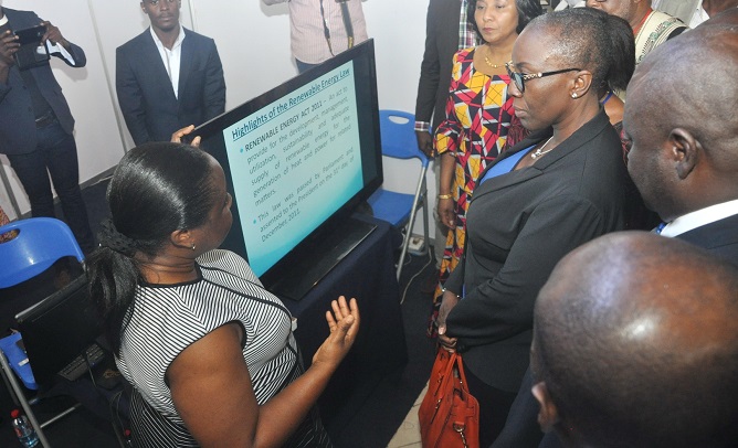 Mrs Gifty Tettey (left), Deputy Director, Bioenergy, Ministry of Power, explaining some of the energy procedures at the fair to Mrs Marrieta Appiah Opong (3rd right in Accra. Also with them is Mrs Mona Quartey (left). Picture: SAMUEL TEI ADANO