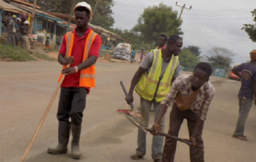 Right: Workers of Hardwork Company Limited working on the resurfacing of the Ofoase-Chia portion of the road. Picture: SAMUEL KYEI-BOATENG