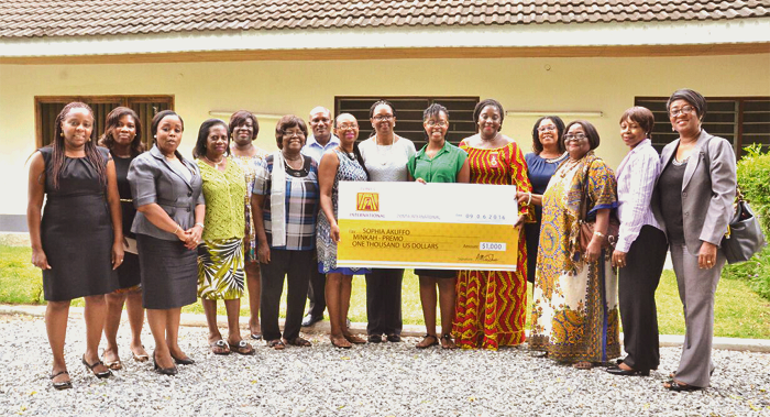  Ms Minka-Premo (sixth right) displaying the dummy cheque in the company of some Zonta members.