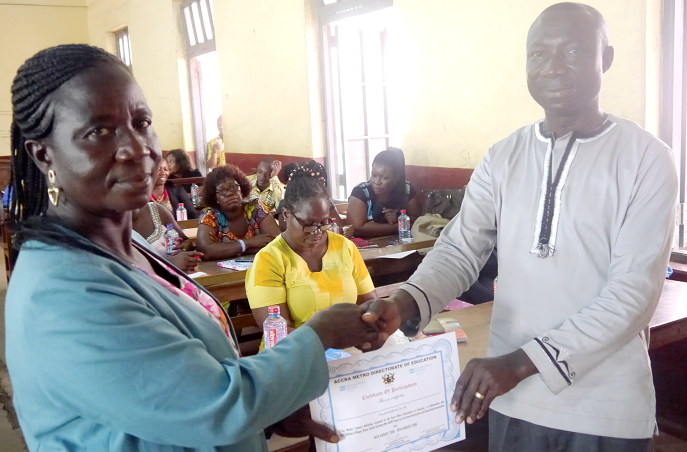 Mr George Yaw Boateng (right), the Programme Coordinator,  presenting a certificate to Mrs Alice Akua Twum, a participant,  at the ceremony    Picture: PATRICK DICKSON