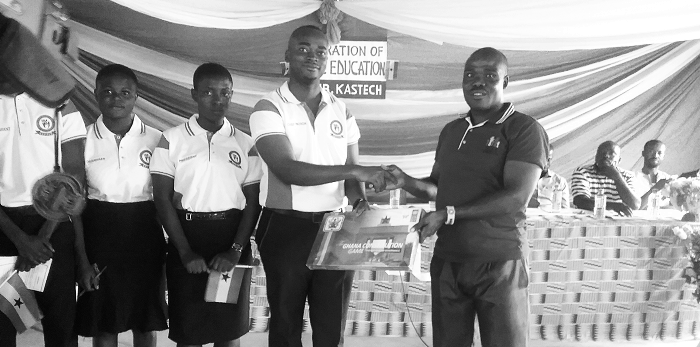  Mr Godwin Opoku Yeboah (right), the Mampong Municipal Programmes Officer of the NCCE,  presenting Costitutional Game to the Chief Patron of the club, Daniel Adusei Konadu  