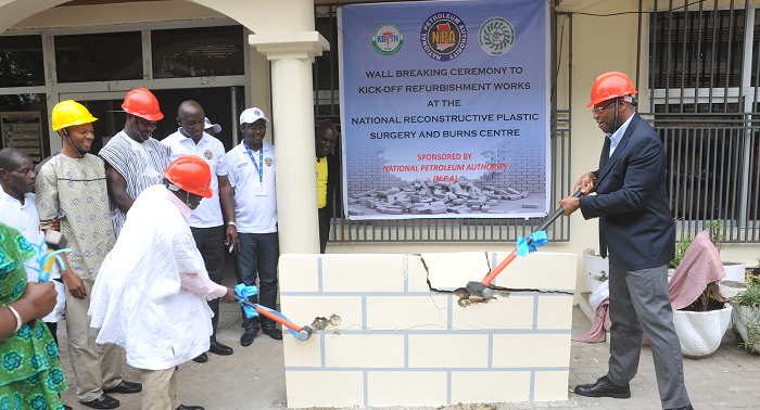  Mr Moses Asaga (left) and Dr Gilbert Buckle, CEO of the Korle Bu Teaching Hospital, jointly performing the wall-breaking ceremony. Picture: EBOW HANSON