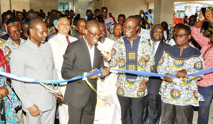 Mr Fifi Kwetey, Minister of Transport, cutting the ribbon to officially inaugurate the Ghana Shippers Authority House. Looking on are Mr Kofi Mbeah, Mr Essien (left) and some officials of the authority. Picture: EBOW HANSON