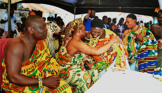  Obrempong Nyanful Krampah XI, Omanhene of the Gomoa Ajumako Traditional Area, embracing Nana Efua Esiwaa II during the ceremony