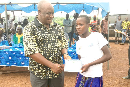 Mr Kumah presenting a certificate to one of the CBE beneficiaries during their graduation
