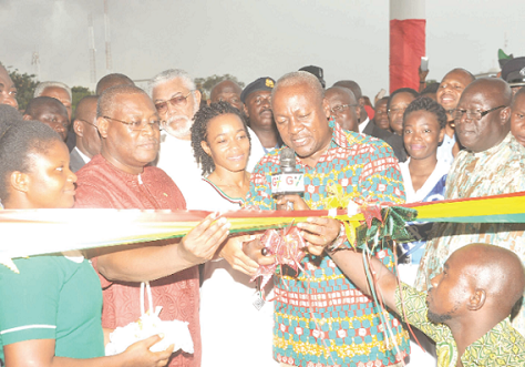 President Mahama assisted by Mr Alex Segbefia (left) and Dr Zanetor Rawlings to cut the tape to officially inaugurate the hospital. Also in the picture is Former President Jerry John Rawlings. Picture: EBOW HANSON & DOUGALS ANANE-FRIMPONG