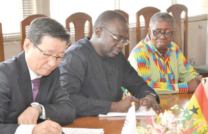   Mr Awuah Darko (middle) MD of TOR and Mr Yik Sik Min (left) CEO of Osun Engineering signing the agreement while a board member of TOR looks on.