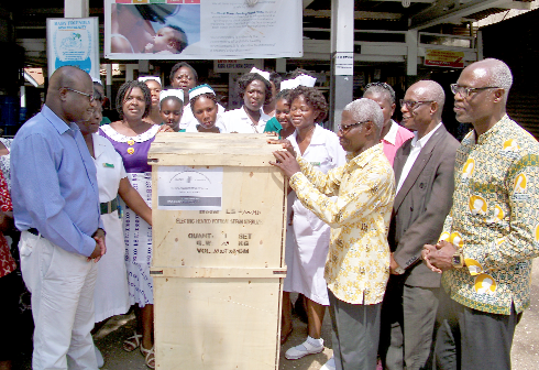 Dr Patrick Amo-Mensah (left), Medical Director of the Kaneshie Polyclinic, receiving the machine from Dr Okoe Trebi Hammond (3rd right). Looking on are some members of the SDA and nurses of the Kaneshie Polyclinic