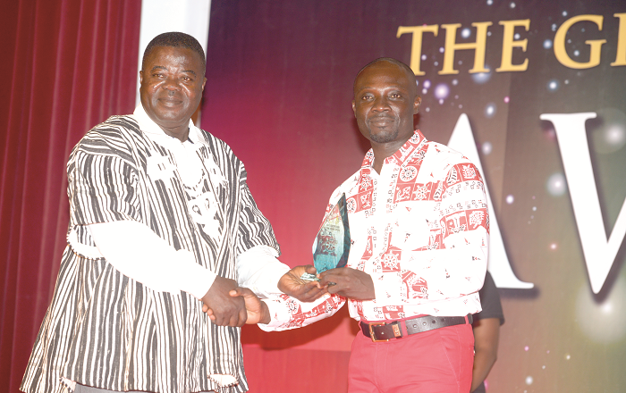  Coach Kwame Adipah receiving his award last Friday from the Division One League Board chairman Owoahene Kwasi Acheampong.