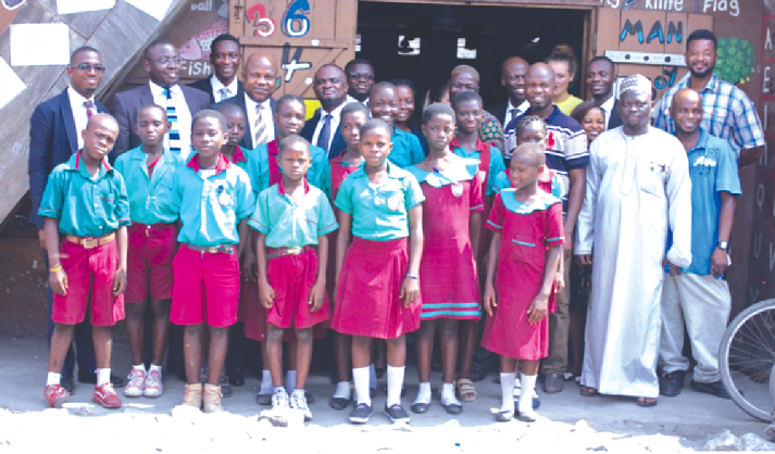  Officials of Wapic Insurance in a group photo with the pupils and teachers  of the school.