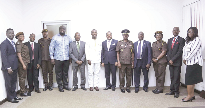  Mr Emmanuel Adu-Sarkodee (middle), Rev Dr Stephen Wengam, (6th right), Mr Emmanuel Yaw Adzator (5th right), the acting Director-General of Prisons, other management members of the CDH Financial Holdings and the Ghana Prisons Council.  Picture:  ESTHER ADJEI