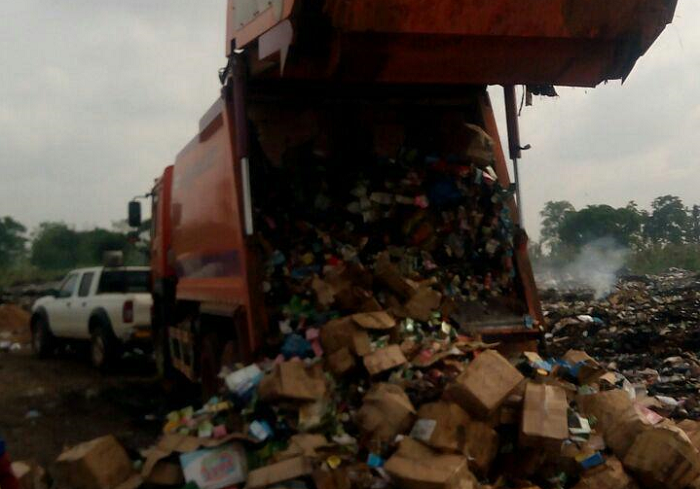  The unwholesome goods being offloaded at a refuse dump for destruction