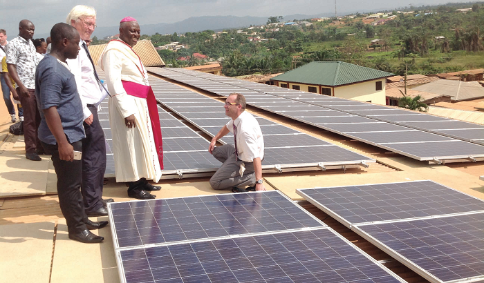  The Project Manager, Prof. Thorsten Schneiders (squatting), explaining how the solar modules would function to Mr Norbert Schneider (2nd left), a nephew of the late Fr Kruze, and the Most Rev Afrifah-Agyekum, the Catholic Bishop of Koforidua.