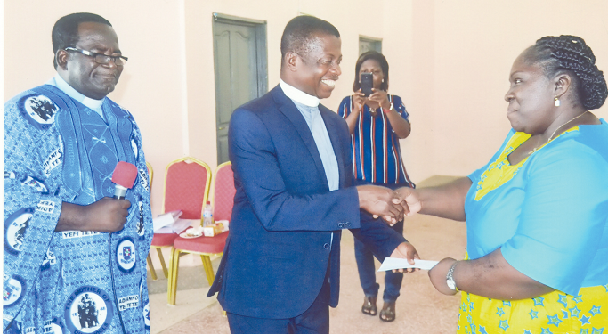 Dr Esther Ofei-Aboagye (right) presenting an award to Rev. Anokye Nkansah, a former tutor of the school. Looking on is Rev. Samuel Yeboah Antwi