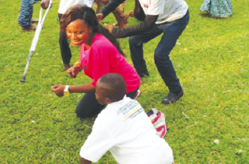  The C.E.O of Ade’s Event, Miss Adelaide Boateng, dancing with some persons with disability .