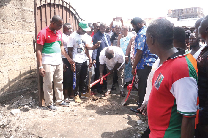  Mr Julius Debrah (with pickaxe) performing the sod-cutting 