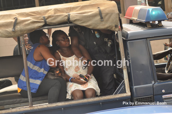 The two suspects in the police vehicle being transported to the police station. PICTURES BY EMMANUEL BAAH
