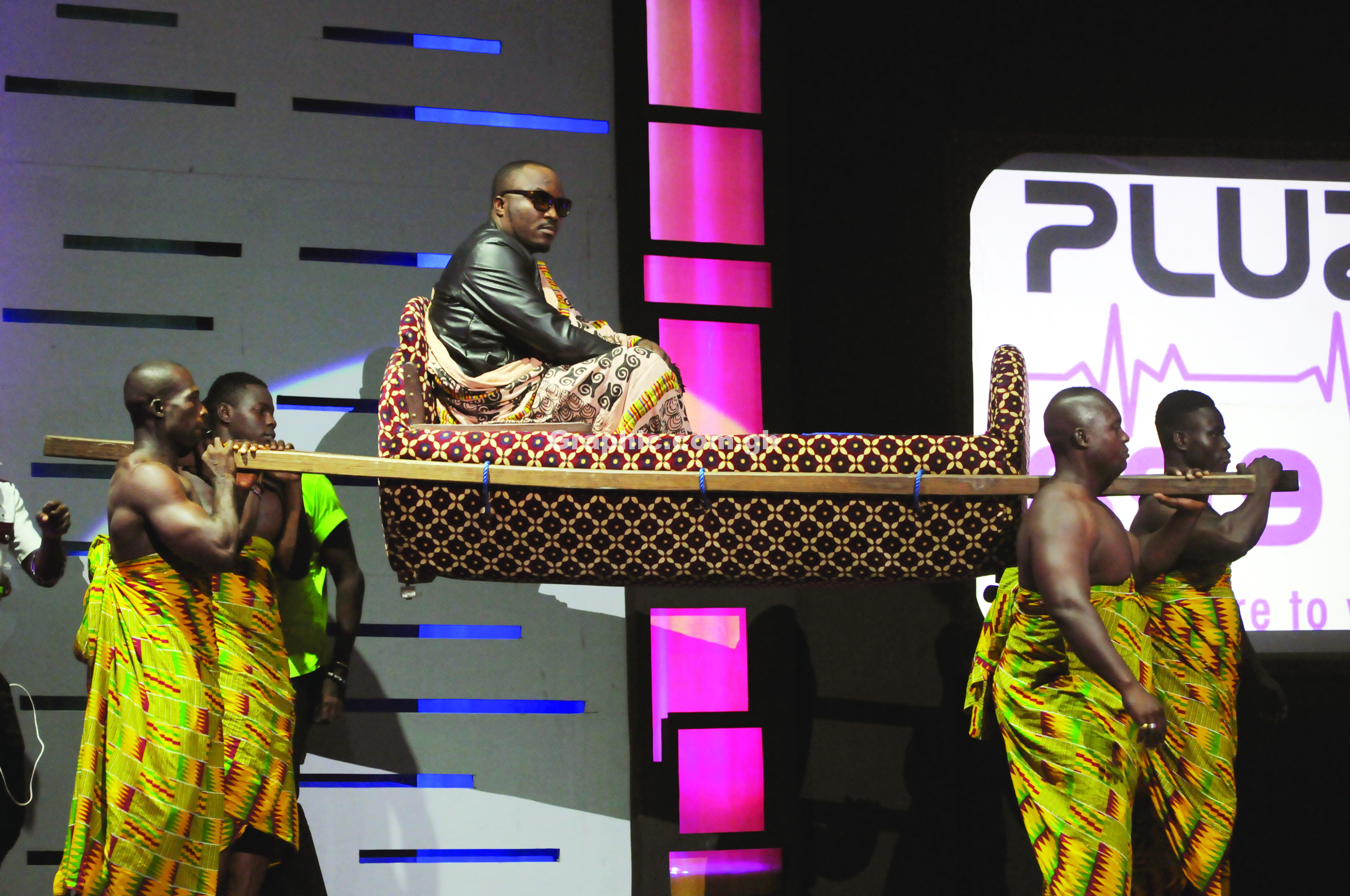 DKB arriving on stage in a palanquin