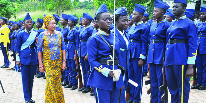 Mrs Sylvia Yerenkye (in cloth)  inspecting a guard of honour mounted by the cadet corps