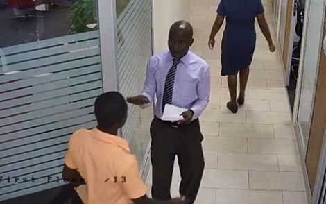 File photo: This man was caught on a CCTV camera sometime in March when he posed as a worker of a bank and allegedly swindled the boy who had been sent to make a deposit. 