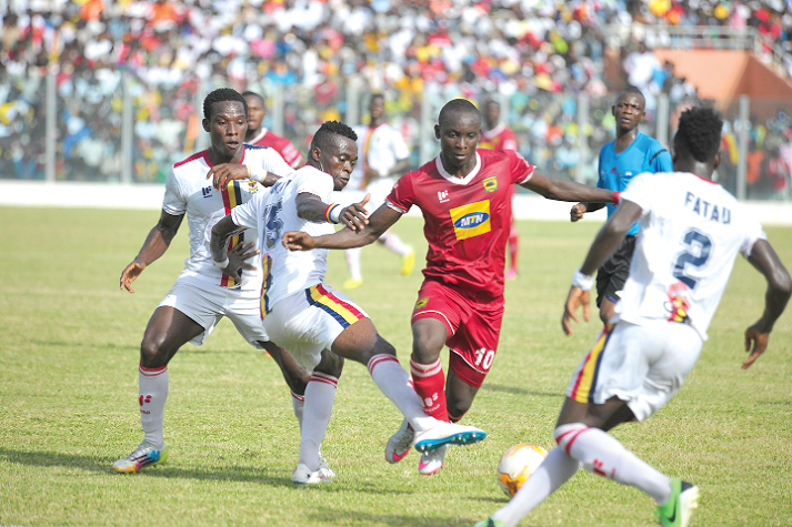 Flashback: Asante Kotoko striker Dauda Mohammed takes on two Hearts players during the first round match in Accra.
