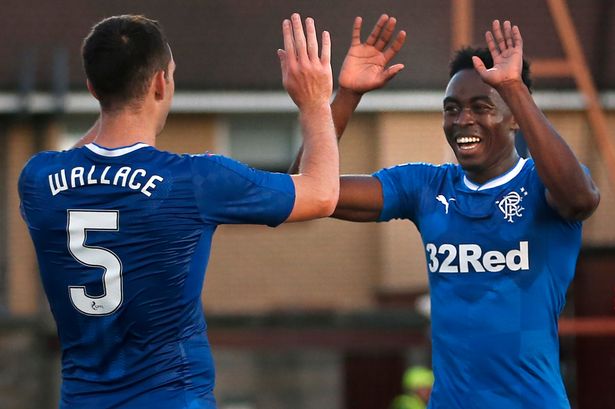 Rangers' Joe Dodoo celebrates scoring his side's third goal with team-mate Lee Wallace