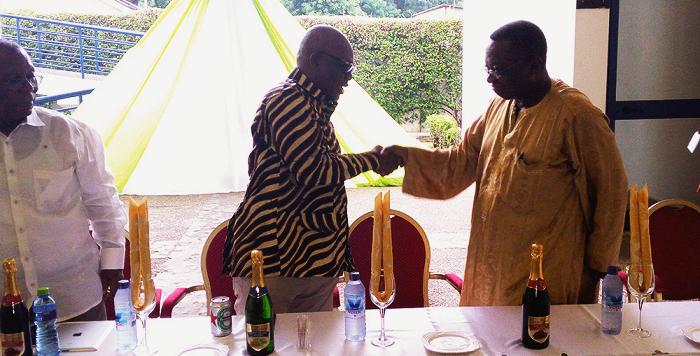  Mr John Kudalor  (left), the Inspector General of Police (IGP), shaking hands with one of the old students at the ceremony
