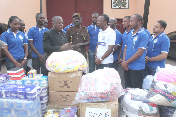  Bishop Bentil (in white top) and his team listening to comments from  Rev. Martin Padi after receiving the items on behalf of the Nsawam Prisons.