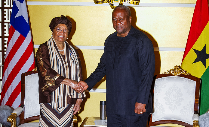 President Mahama in a handshake with President Ellen Johnson Sirleaf
