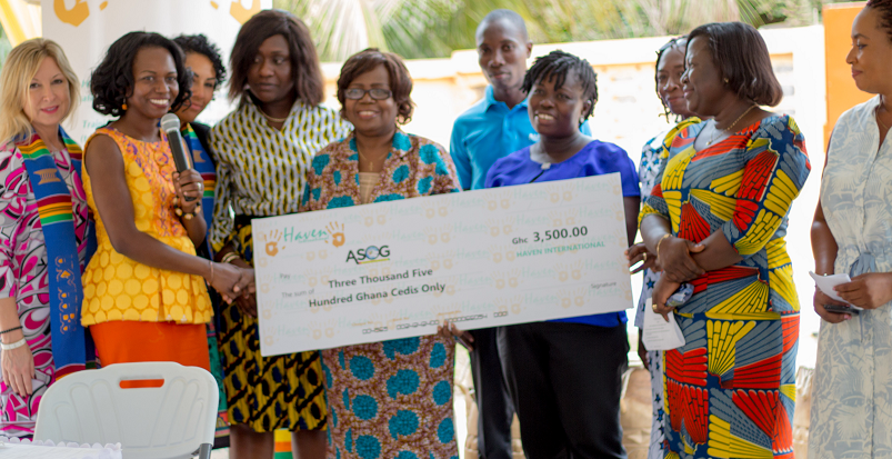 Dr Kumapley presenting a cheque to Madam Serwaa of the Autism Awareness Care and Training
