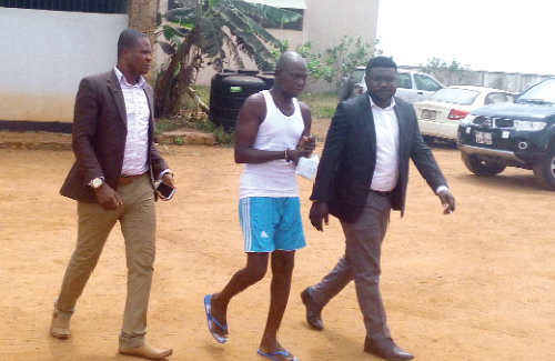 Thomas Kofi Owusu (in handcuffs) being led out of the court premises after the court proceedings
