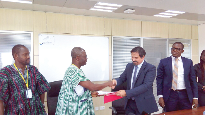  The Chief Executive Officer of SADA, Mr Charles Akelyira Abugre ( left), exchanging the document with the Managing Director of ENI Ghana, Mr Fabio Cavanna
