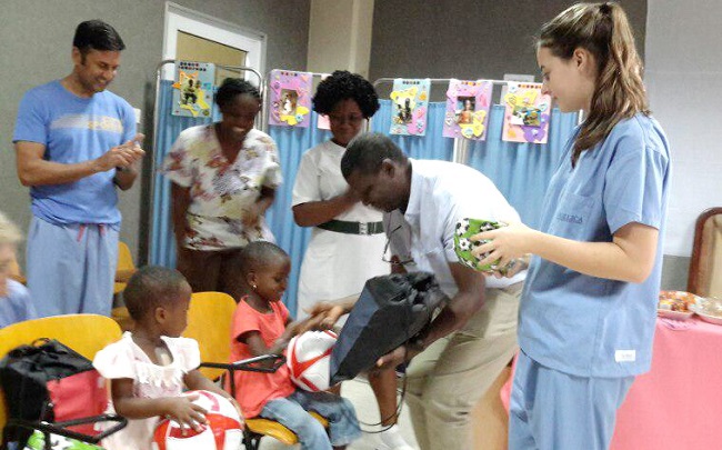 Dr John Adabie Appiah (second right) distributing some items to some of the children whose hearts defects were corrected free of charge. Looking on are some members of the medical team