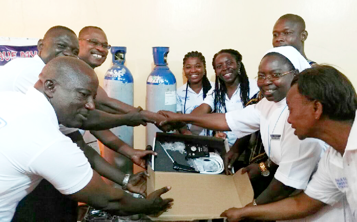 Dr Edward T. Dassah (3rd left) presenting the equipment to the staff of the hospital who received them on behalf of the hospital