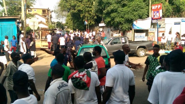A police officer warding-off NDC supporters