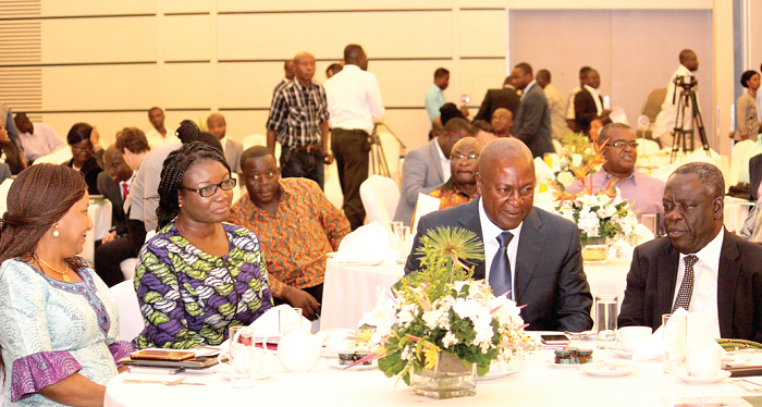   Mr Michael Agyekum Addo (right), CEO, kama Industries in an interaction with President Mahama (2nd right), as Madam Joyce Mogtari (2nd left),  Deputy Minister of Transport and Madam Mona Quartey (left), a deputy Minister of Finance look. Picture: NII MARTEY M. BOTCHWAY