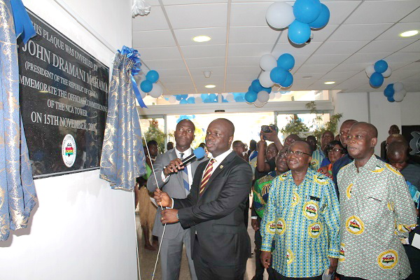 Dr Edward Omane Boamah unveiling the plaque to inaugurate the building. With him are Mr William Tevie (right) and Mr Eugene Baffoe-Bonnie (2nd right), Board Chairman of NCA
