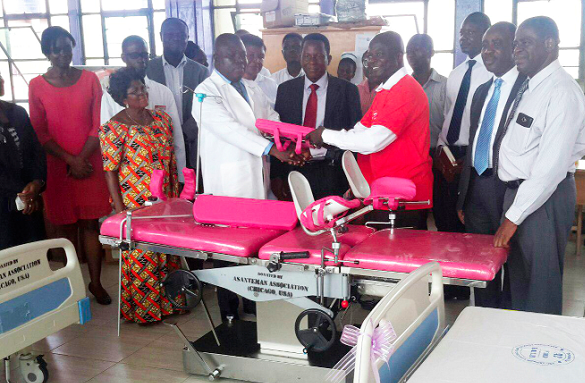 Mr Victor Boafo (right), the Secretary of the Asanteman Association of Chicago, presenting one of the multi-functioning obstetric beds