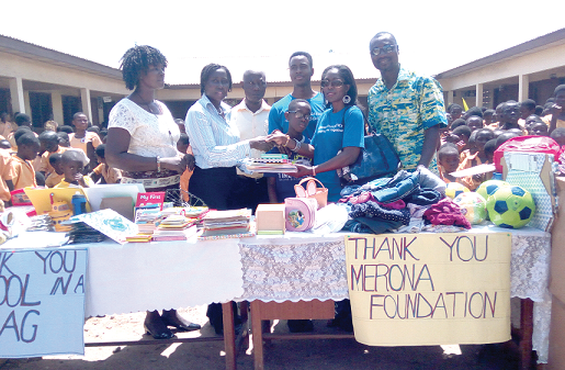Madam Cynthia Oteng (2nd right), Executive Director of the Foundation, presenting the items to Mrs Frances Aboagye, Headteacher of the school