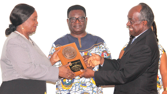 Dr Kofi Mbiah (middle), CEO, Ghana Shippers Authority, being assisted by Prof. Samuel Date-Bah (right) to present a memento to the Chief Justice, Mrs Justice Georgina Theodora Wood (left). Picture: NII MARTEY M. BOTCHWAY