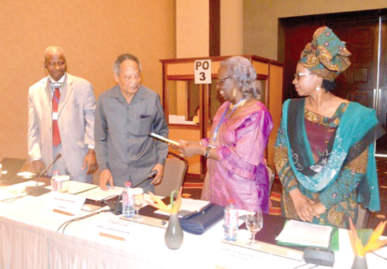 The Chairperson of the commission, Prof. Rose Leke (2nd right), presenting the award to the Prof. Francis Nkrumah (2nd left)