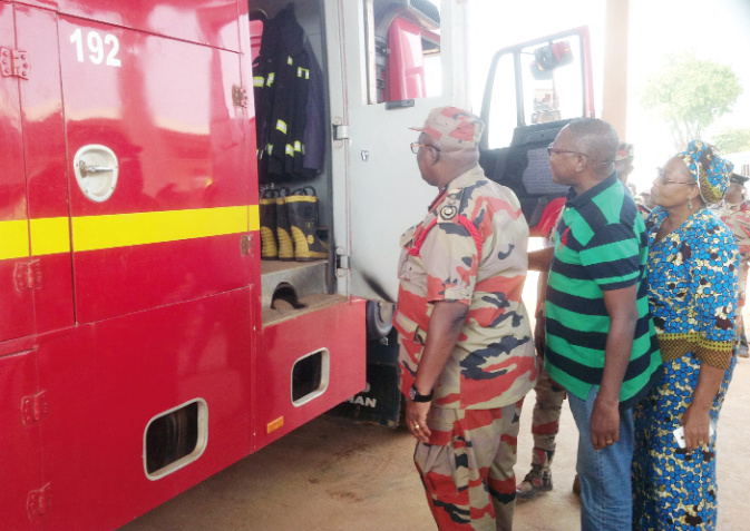 Dr Albert Gaisie being accompanied by Madam Elizabeth Afiuc (first right), the Builsa South District Chief Executive, and Dr Clement Apaak (middle) to inspect one of the fire tenders at Fumbisi after it was inaugurated