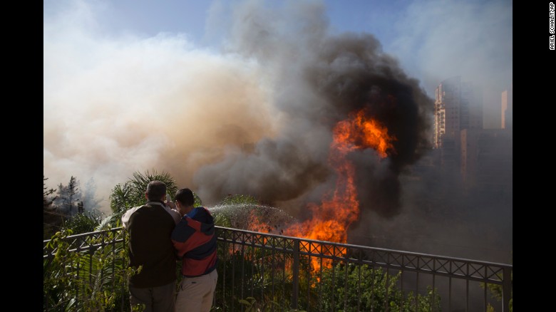 Israel wildfires scorch more land, 60,000 evacuated