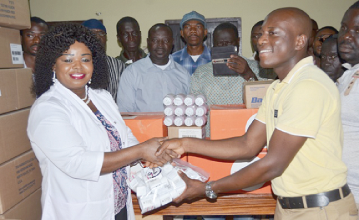 Dr Beatrice Wiafe Addai presenting one of the drugs to Mr Hilton Terry Kessie, a physician assistant at the Lake Bosumtwi Methodist Clinic.