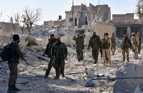Syrian pro-government forces in the Masaken Hanano district in eastern Aleppo on Sunday as regime forces seized it from rebels