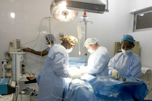The American team performing surgical operation on a patient