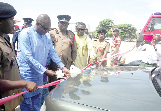 Mr Prosper Bani (2nd left), Minister of the Interior, cutting the tape to declare the 24 fire engines commissioned in Accra. Picture: Emmanuel Quaye