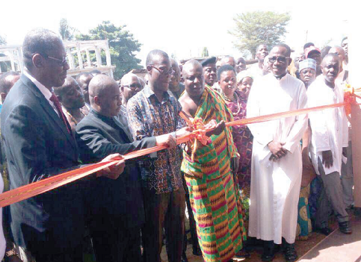 Mr Fifi Kwetey (3rd left), Transport Minister, being assisted by Togbe Fiti to cut the tape to inaugurate the terminal. With them include Mr Ligbi (2nd left), Managing Director, MMT