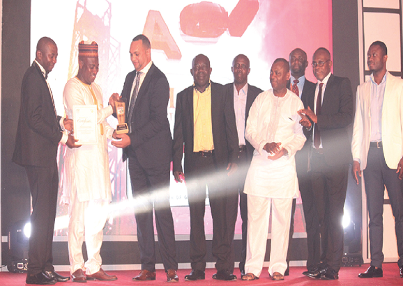 Mr Nichol J. Elizabeth (3rd left), a representative of Pioneer Food Cannery, picking the Overall Best Award from Mr Muturla Mohammed (2nd left)